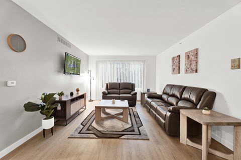 a living room with leather couches and a coffee table