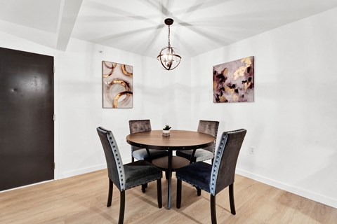 a dining room with a wooden table and chairs