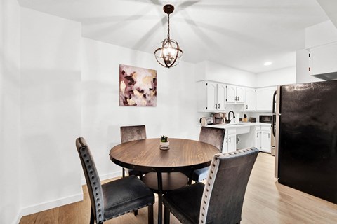 a dining room with a table and chairs and a kitchen