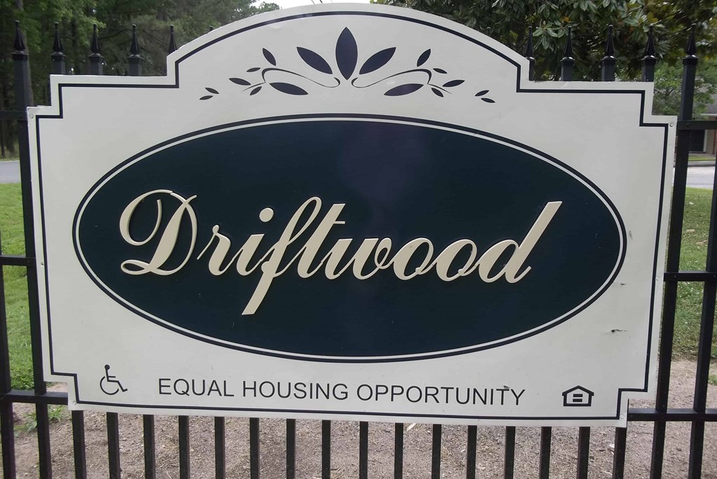 the sign for the dillardwood equal housing opportunity sign on a fence