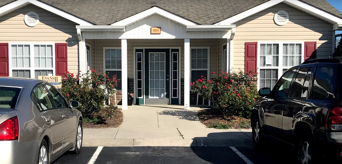 a house with two cars parked in front of it