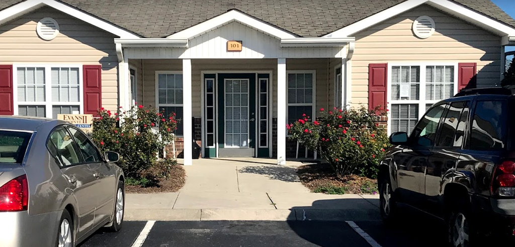 a house with two cars parked in front of it