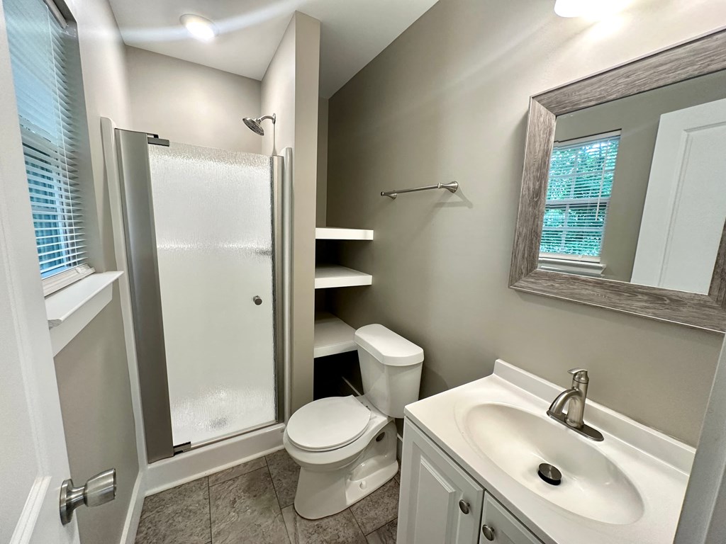 a bathroom with a sink toilet and a shower
