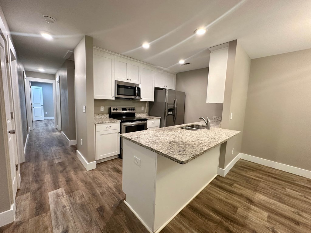 a kitchen with white cabinets and a counter top