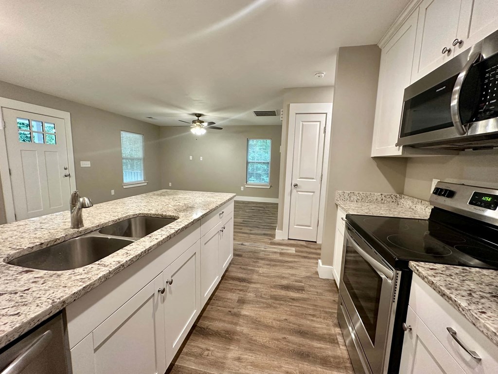 a kitchen with granite counter tops and a sink