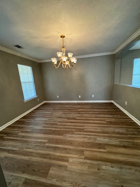 a empty living room with wood floors and a chandelier