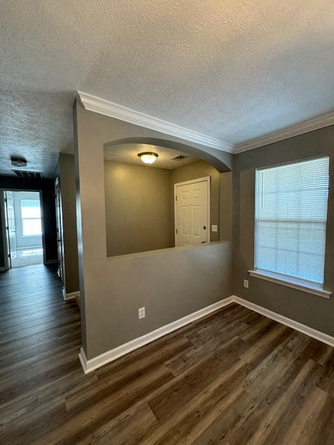 an empty living room with a large window and wooden floors