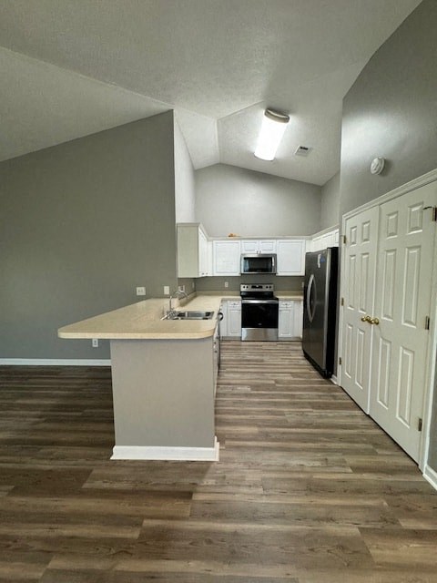 an empty kitchen with a sink and a refrigerator