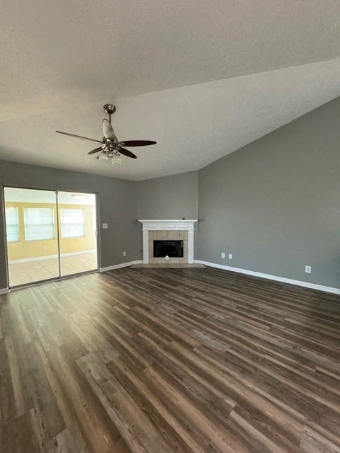 an empty living room with a ceiling fan and a fireplace