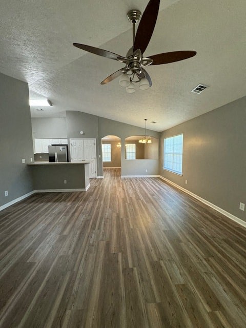 an empty living room with a ceiling fan