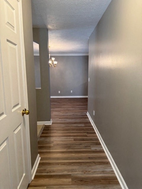 a hallway with wooden floors and a white door