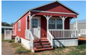 A red house with white trim and a porch.