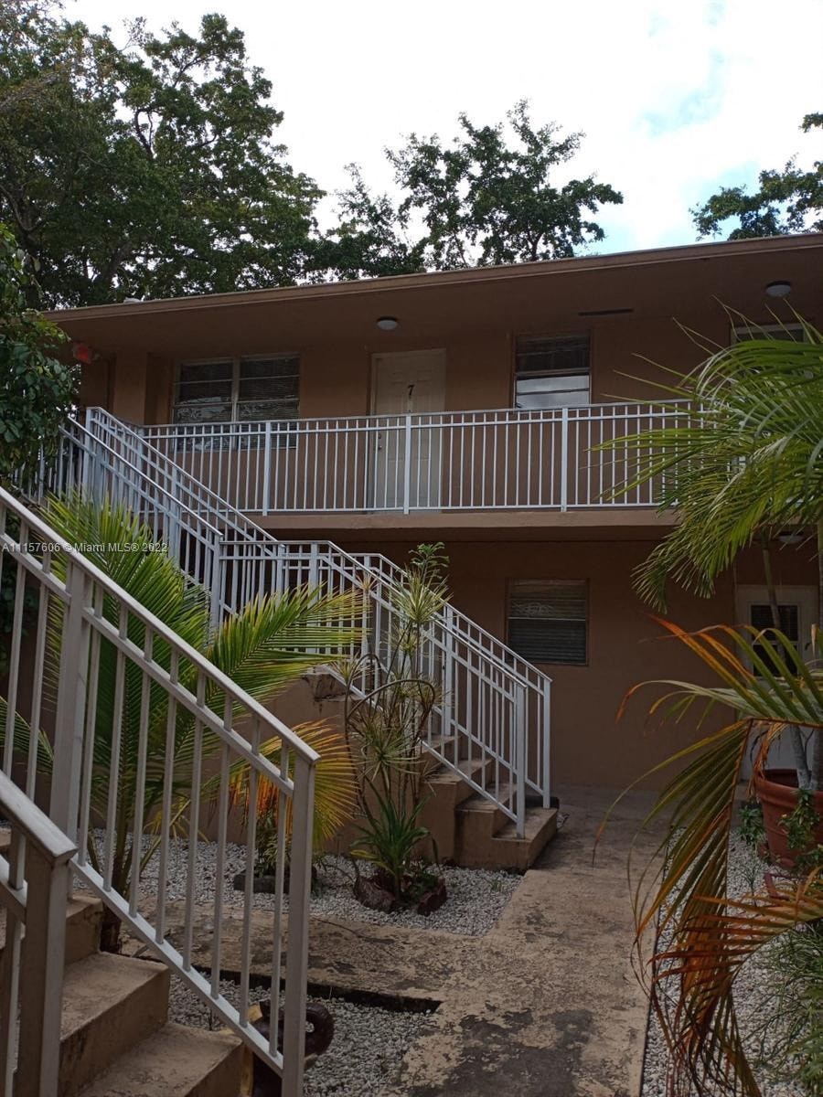 an apartment building with stairs and a courtyard