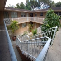 an apartment building with a balcony and a balcony railing