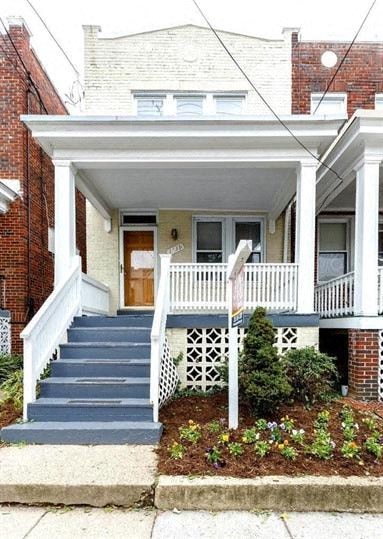 a small house with a white porch and stairs