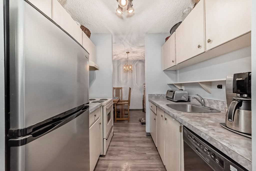 a kitchen with stainless steel appliances and white cabinets