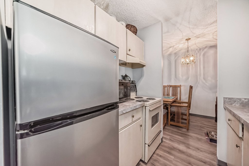a kitchen with stainless steel appliances and white cabinets