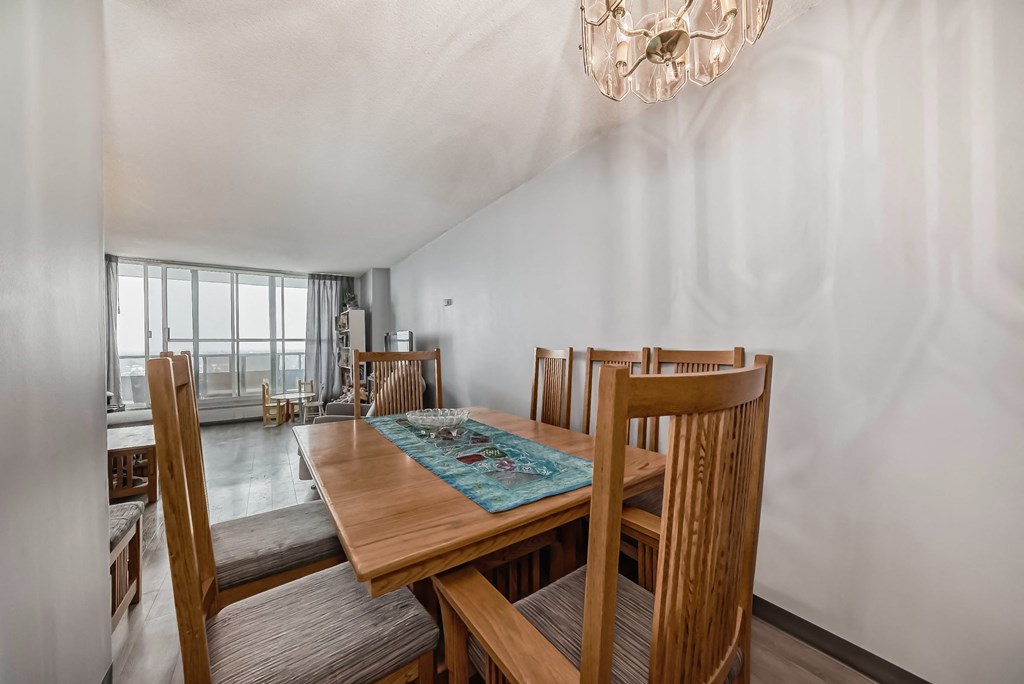 a dining room with a wooden table and chairs