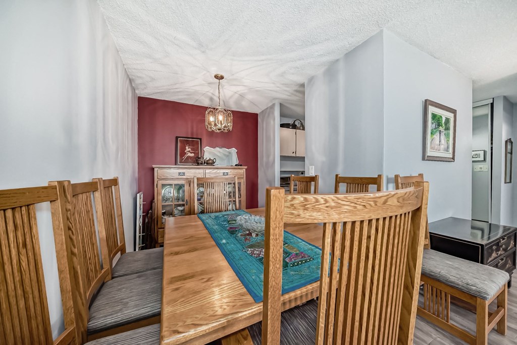 a dining room with a wooden table and chairs