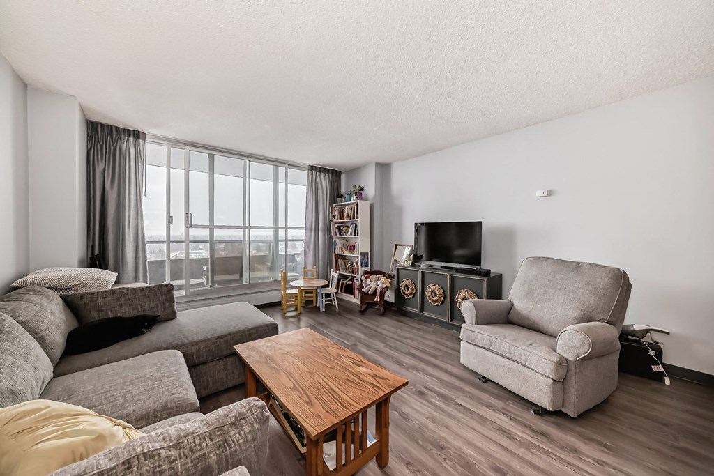 a living room with a couch and a chair and a tv