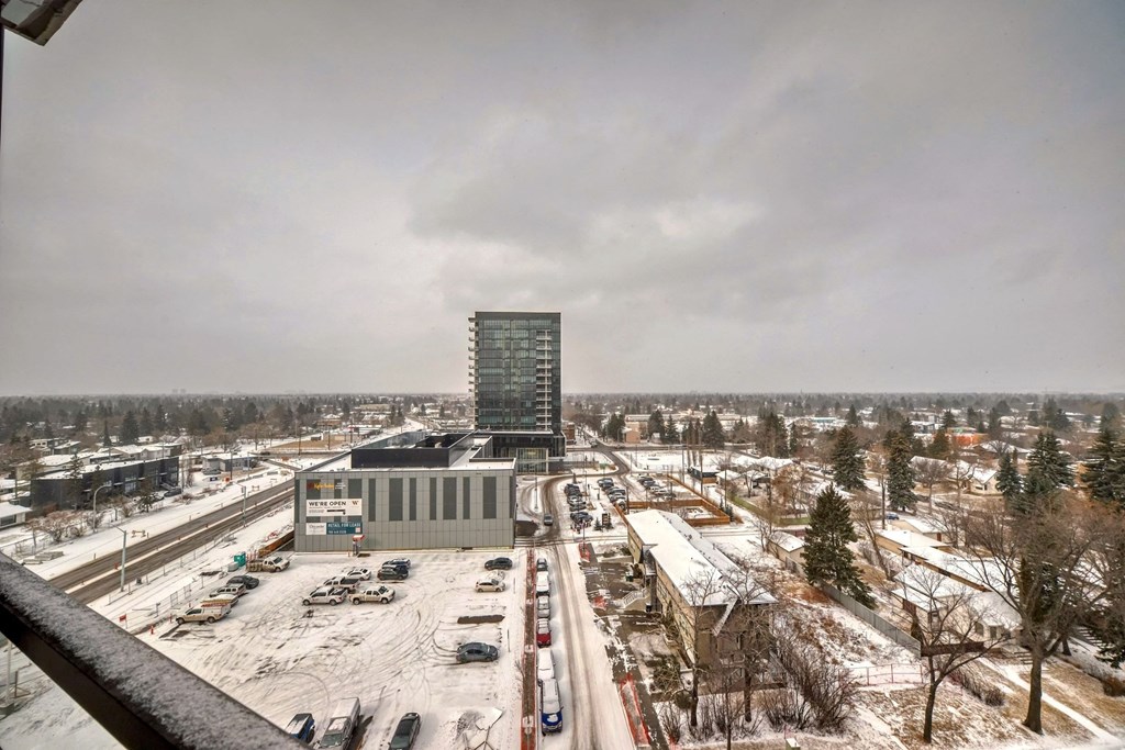 a view of a city from a balcony in the snow