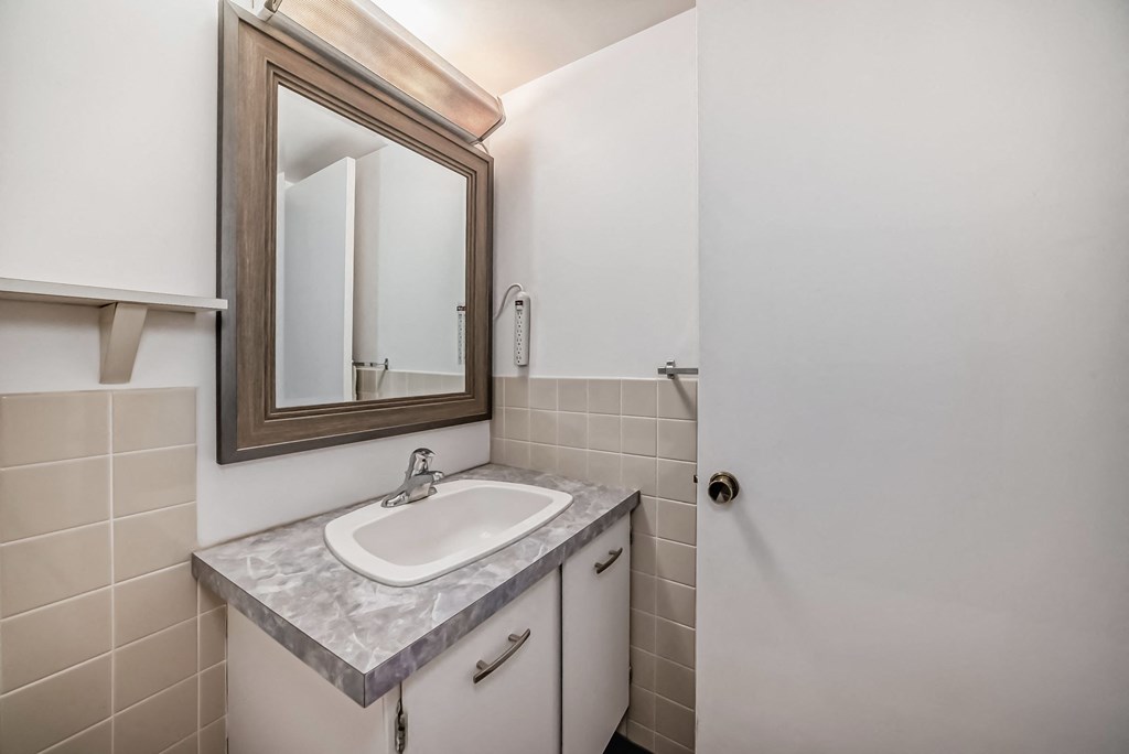 an empty bathroom with a sink and a mirror