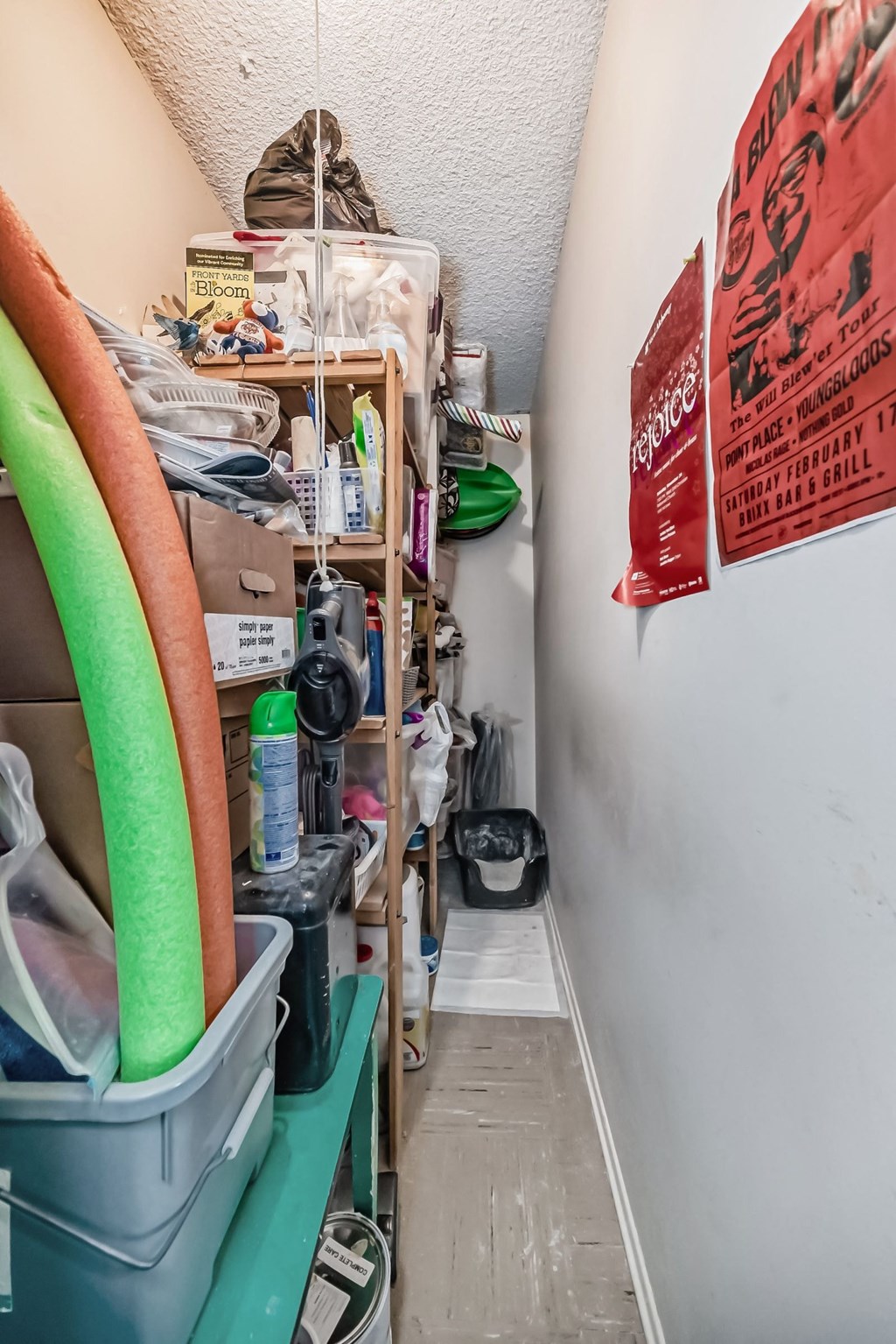 a small room with a shelf of surfboards and other items