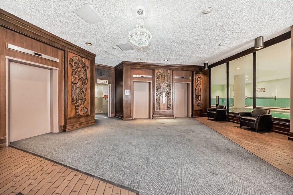 a large room with a carpeted floor and glass doors