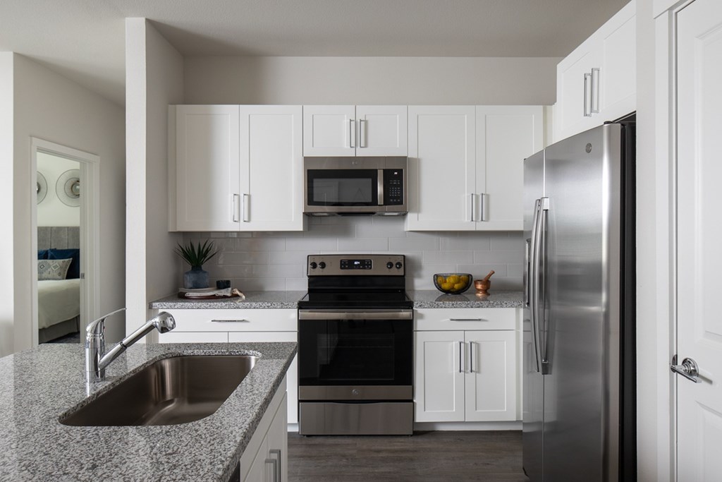 a kitchen with stainless steel appliances and granite counter tops