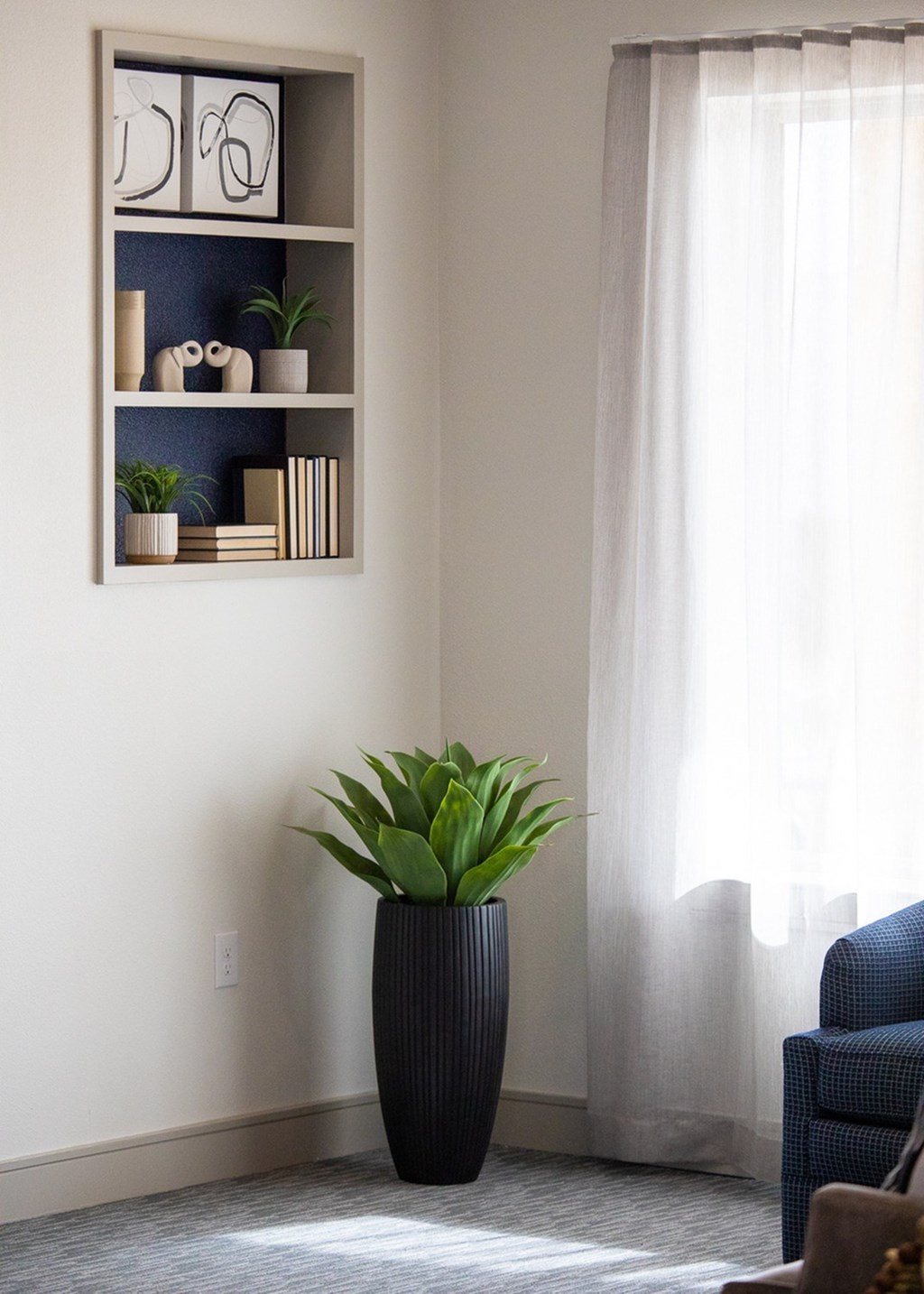 a vase with a plant in a living room