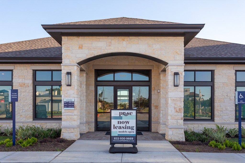 a building with a sign that reads press now leasing