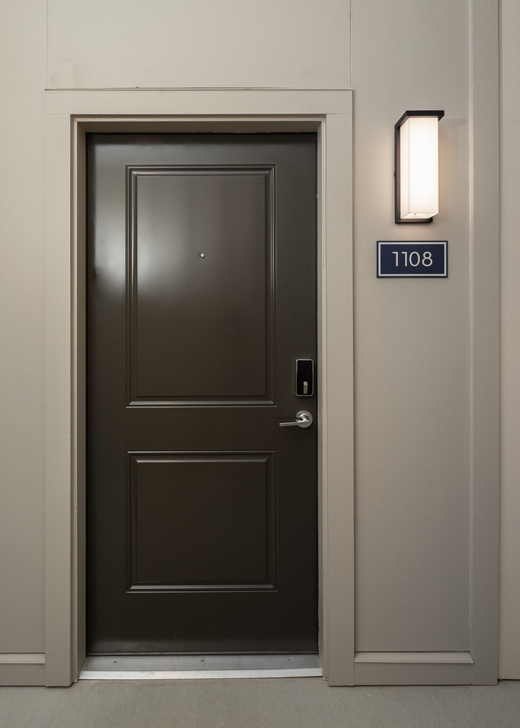 a black door with the number 1100 on the side of it