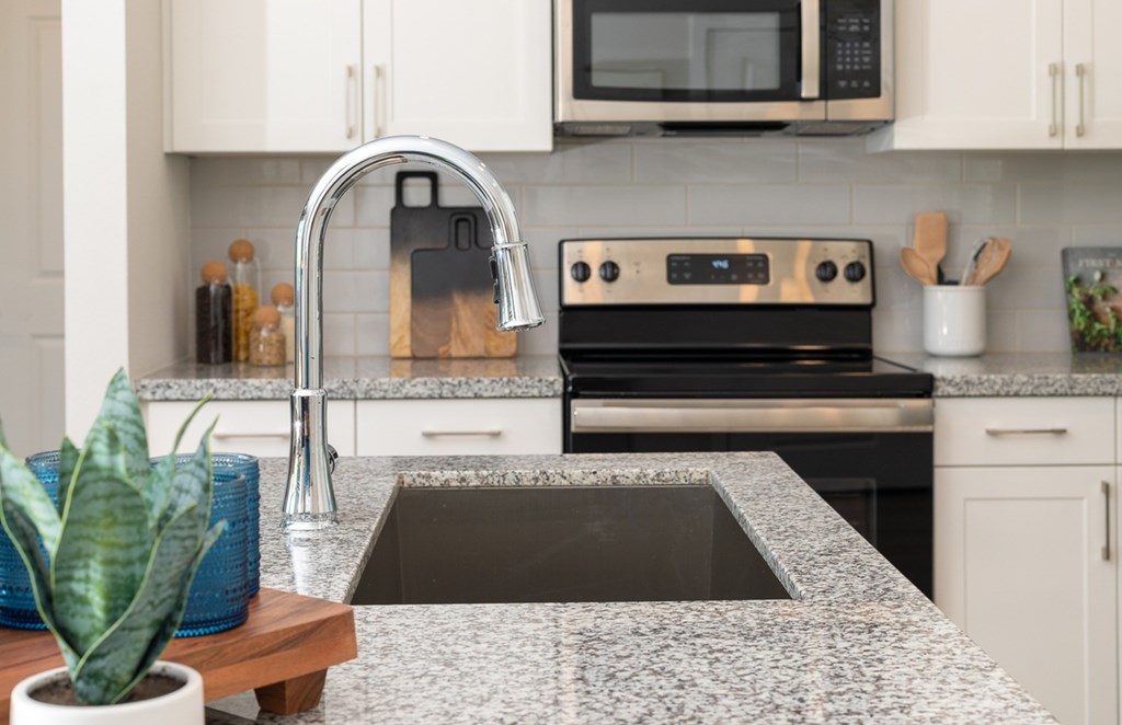 a kitchen with granite counter tops and a sink