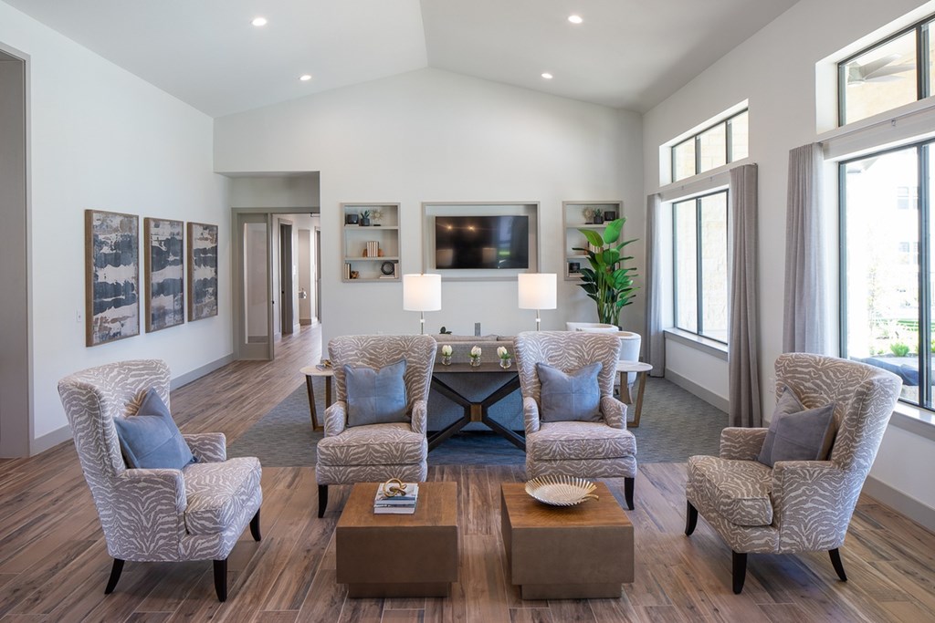 a living room with couches and chairs and a table