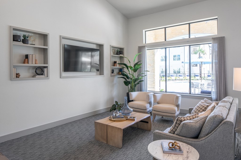 a living room with a couch and a coffee table and a television
