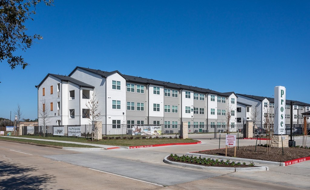 an exterior view of an apartment building on a city street