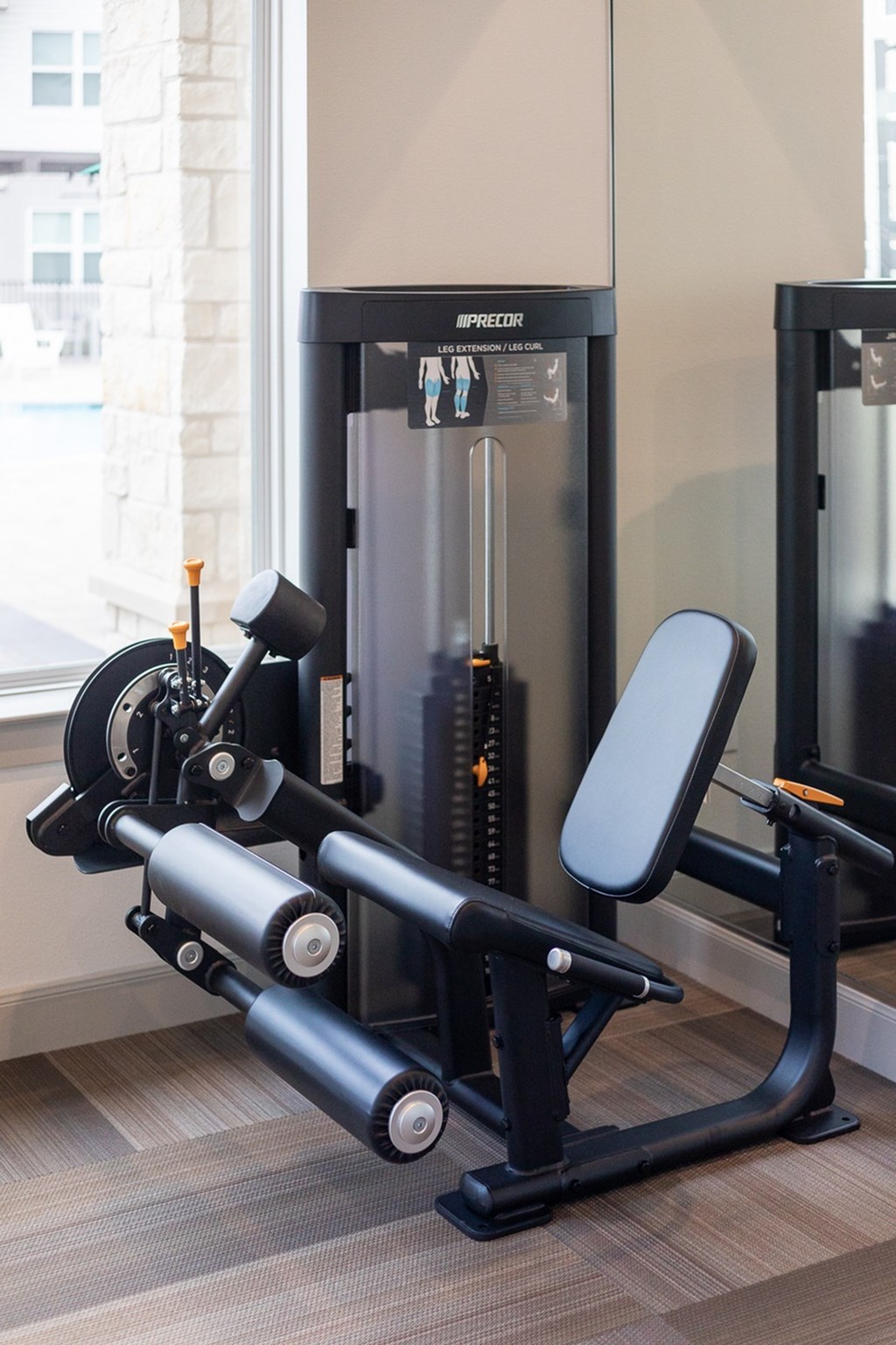 a home gym with a exercise bike and a refrigerator