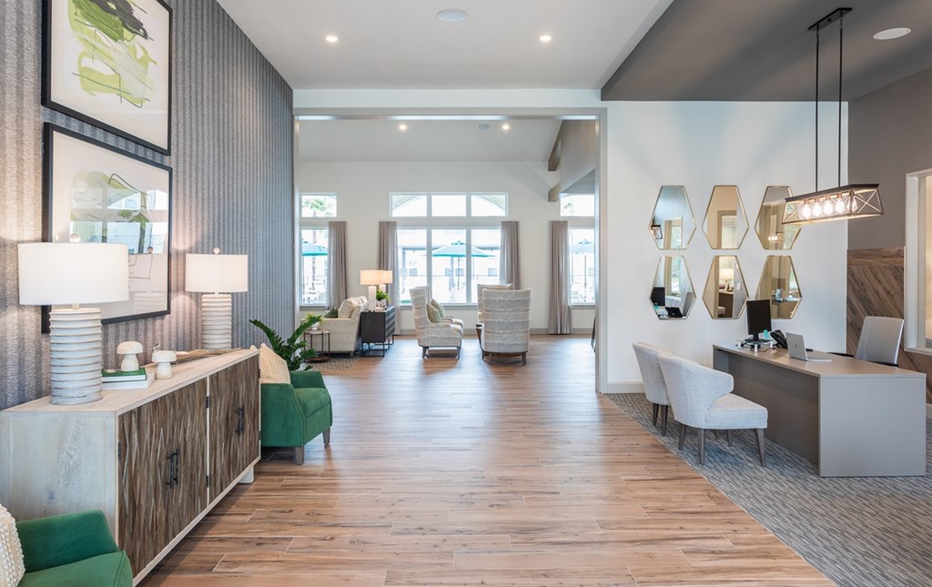 a large living room with a wood floor and white walls