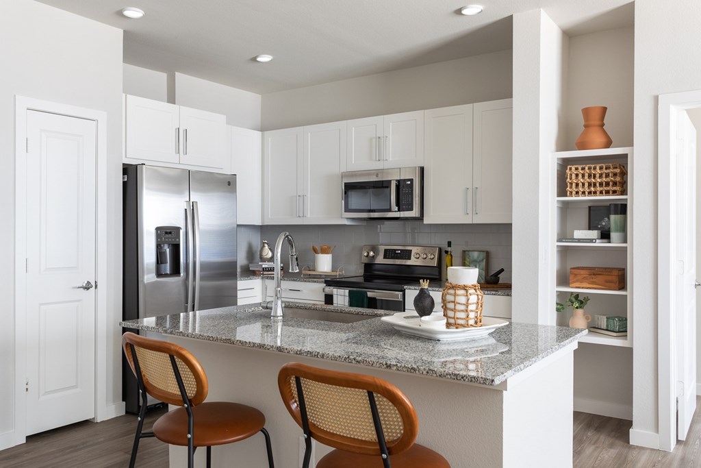 a kitchen with stainless steel appliances and a granite counter top