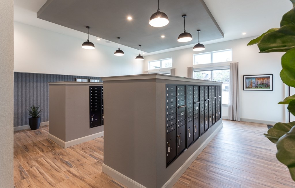 a view of the tasting room with wine racks and a wood floor