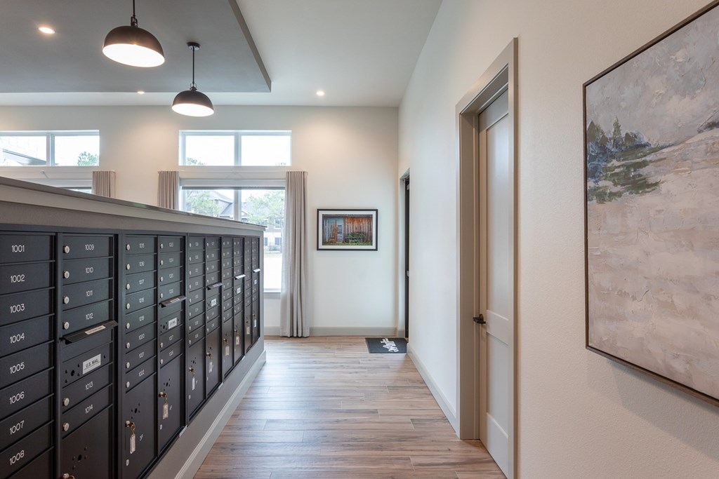 a view of a hallway with lockers and a door