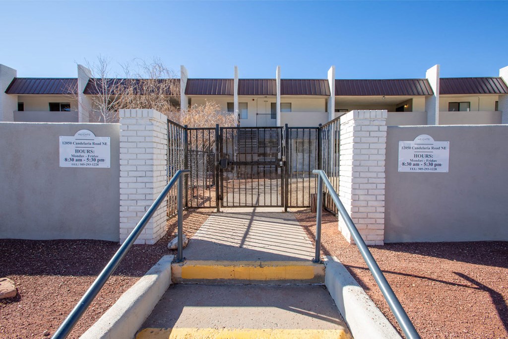 a gate in front of a building with a fence