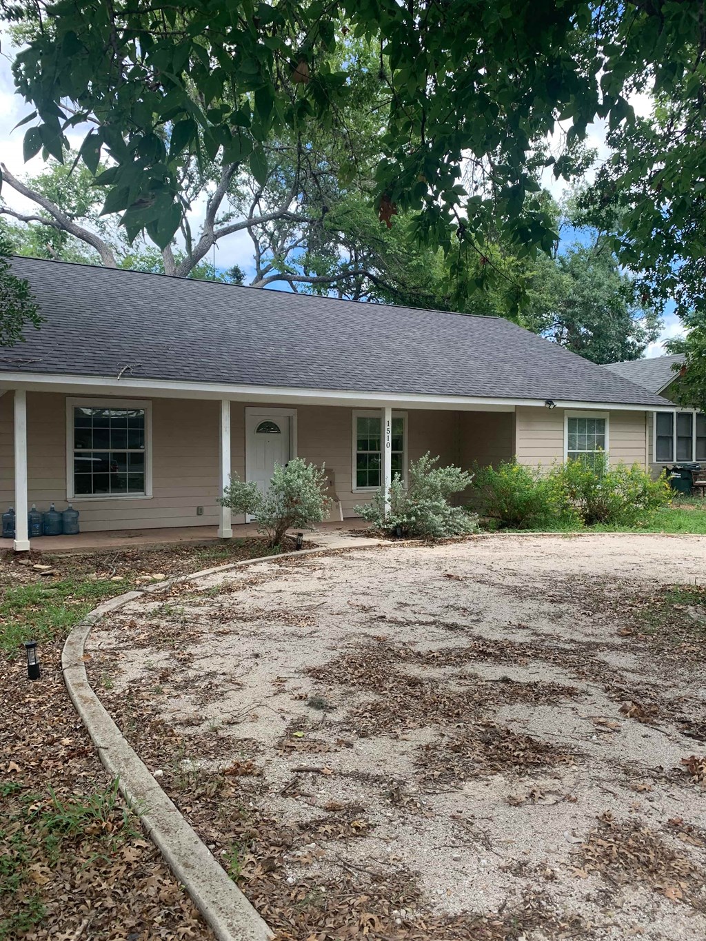a house with a gravel driveway in front of it