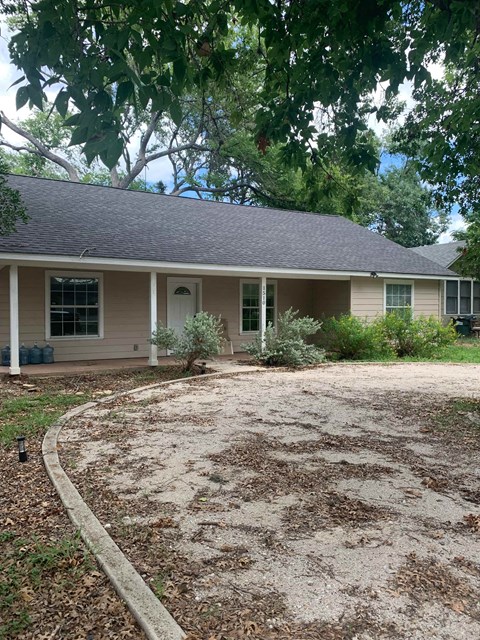 a house with a gravel driveway in front of it