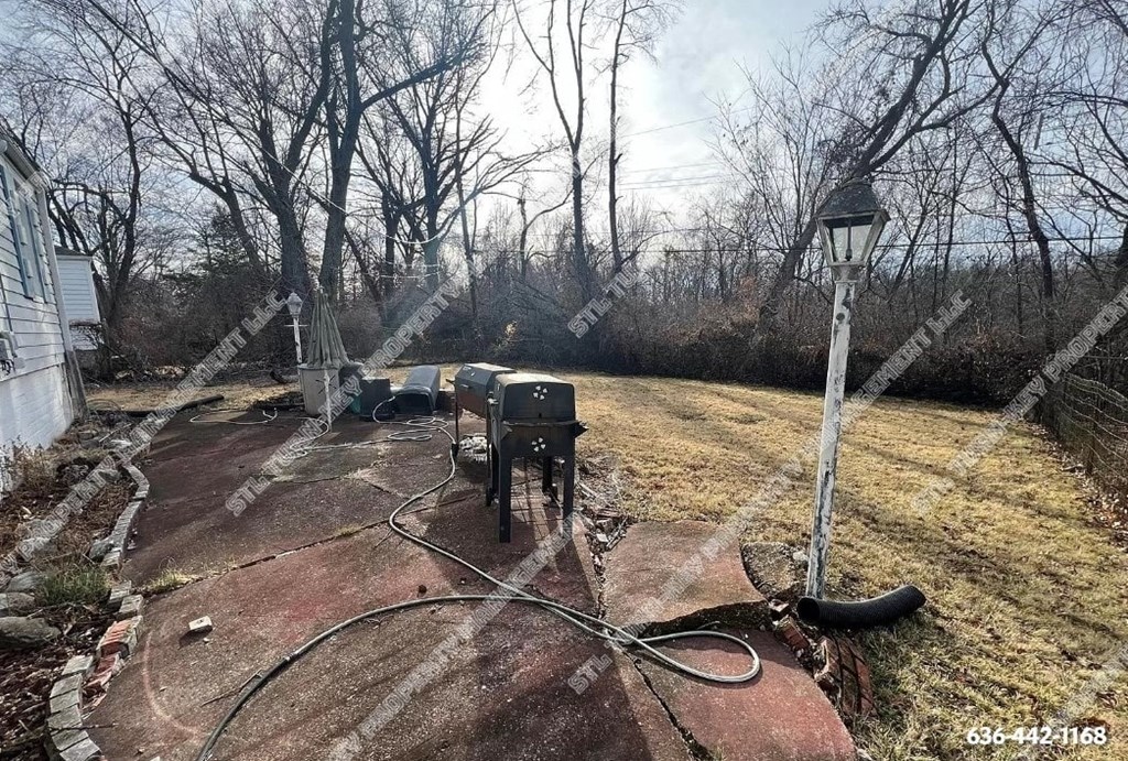 the back yard of a house with a hose on the ground