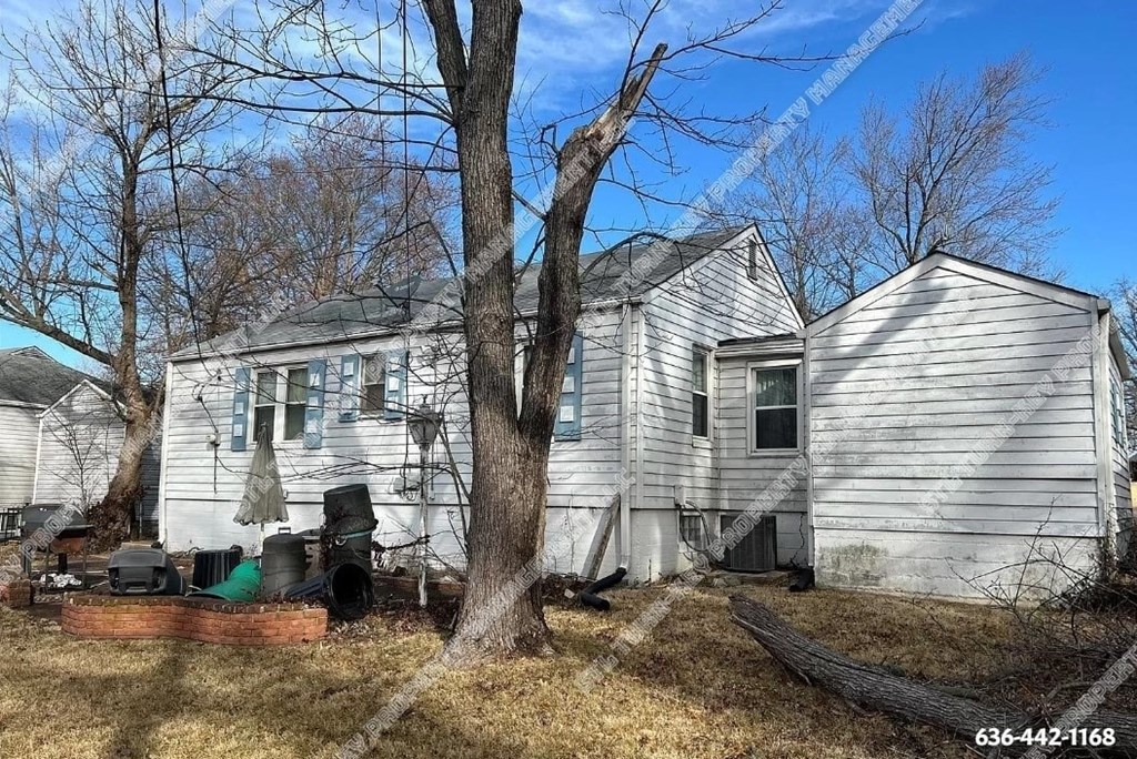 a white house with a tree in front of it