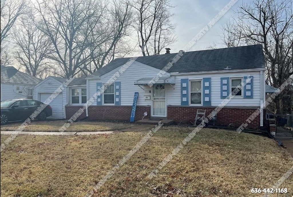 the front of a white house with blue shutters and a lawn