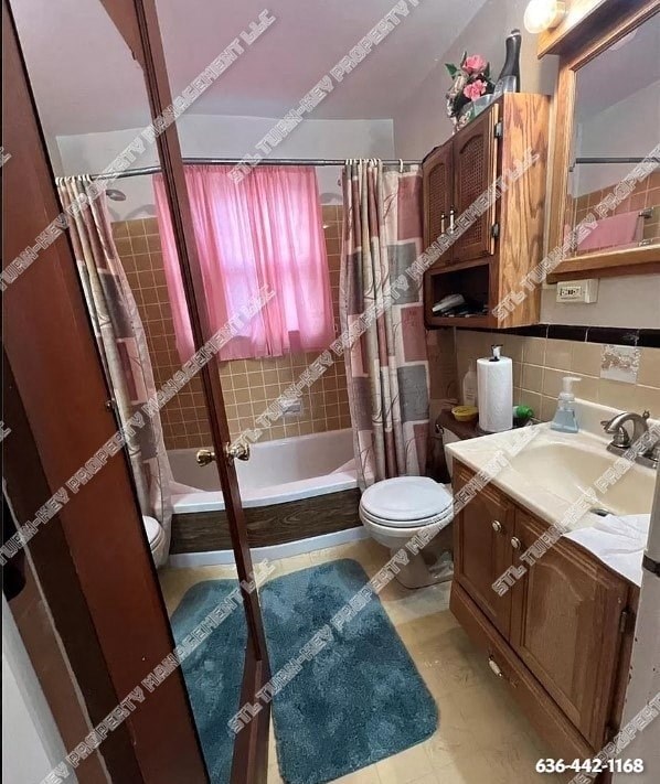 a bathroom with a toilet and a sink and a shower