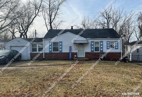 a white house with blue shutters and a yard