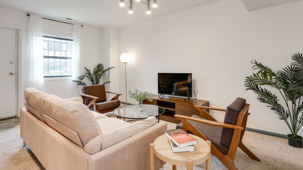 a living room with a couch and chairs and a television